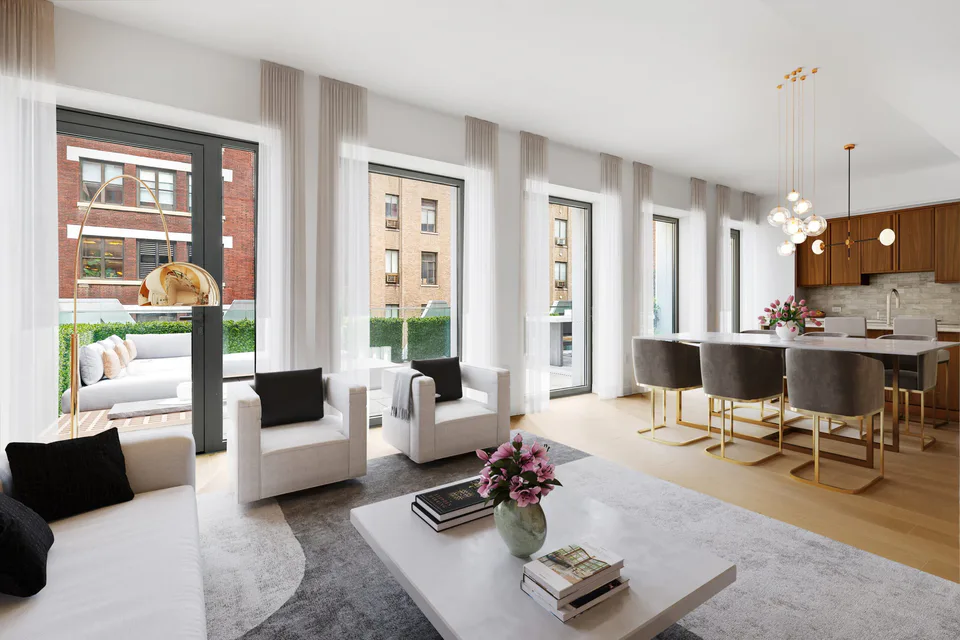 Ninth-floor living, dining and kitchen with floor-to-ceiling windows, white armchairs and a walnut kitchen at Midtown Luxury Residences, 30 East 31 Street, New York City, interior design by Alexandra Peck Design