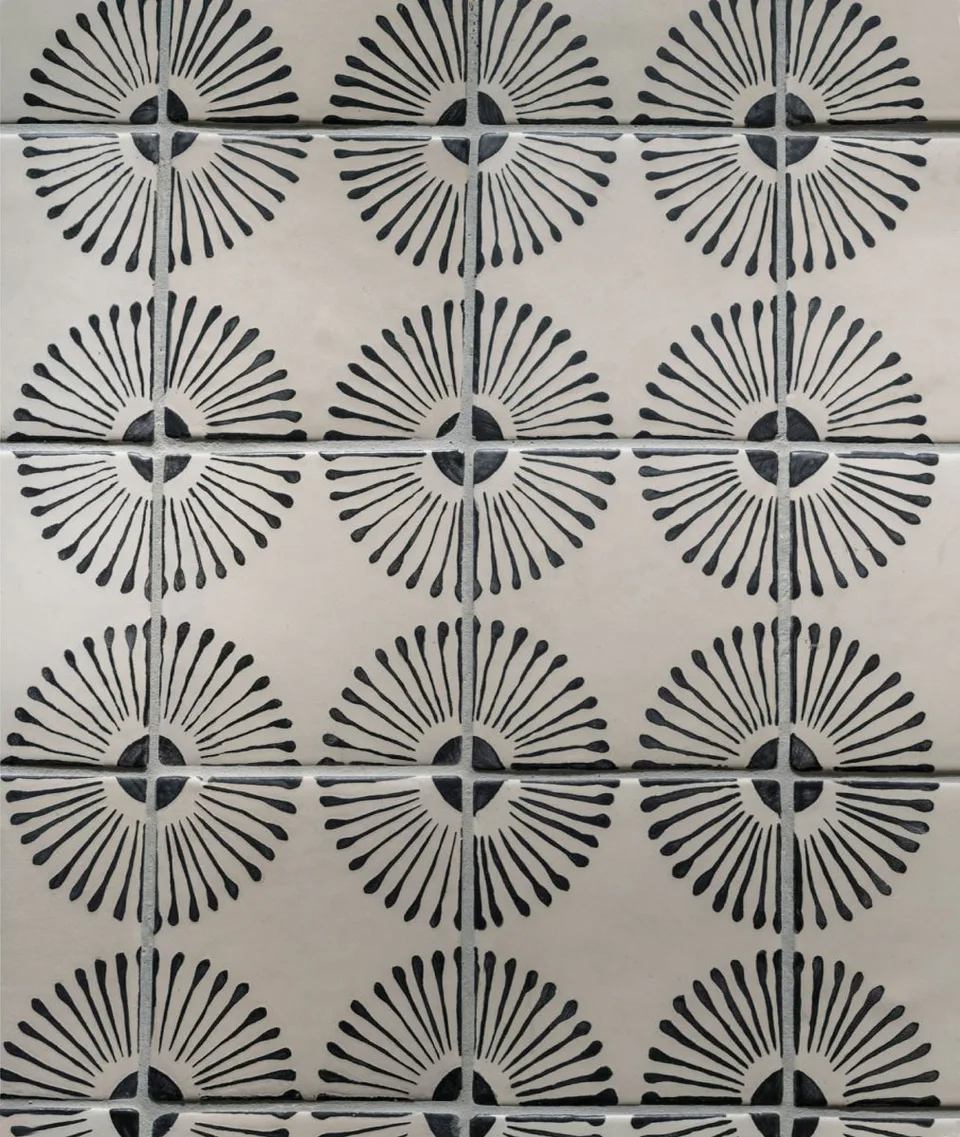Black and white patterned tiles in a bathroom at The Pinch Hotel, Charleston, South Carolina, interior design by Alexandra Peck Design