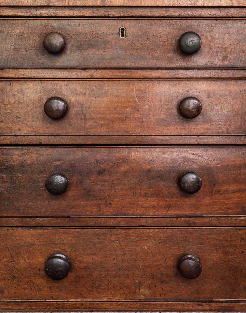 Antique wooden chest of drawers with turned knobs in the hotel lobby at The Pinch Hotel, Charleston, South Carolina, interior design by Alexandra Peck Design